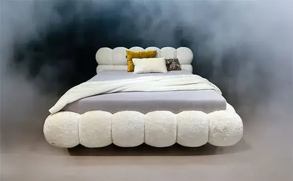 Luxury Balaao Bed by BRETZ with round upholstered elements and cushions in a stylish, dreamy setting